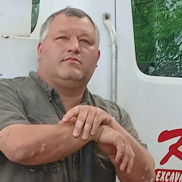 Kevin Kyser beside a K and K Septic truck